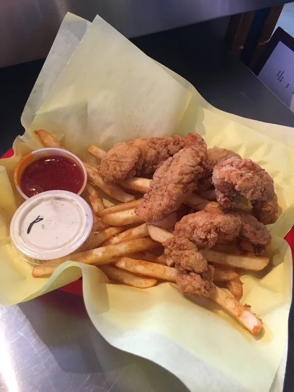 Golden fried chicken tenders with crispy fries